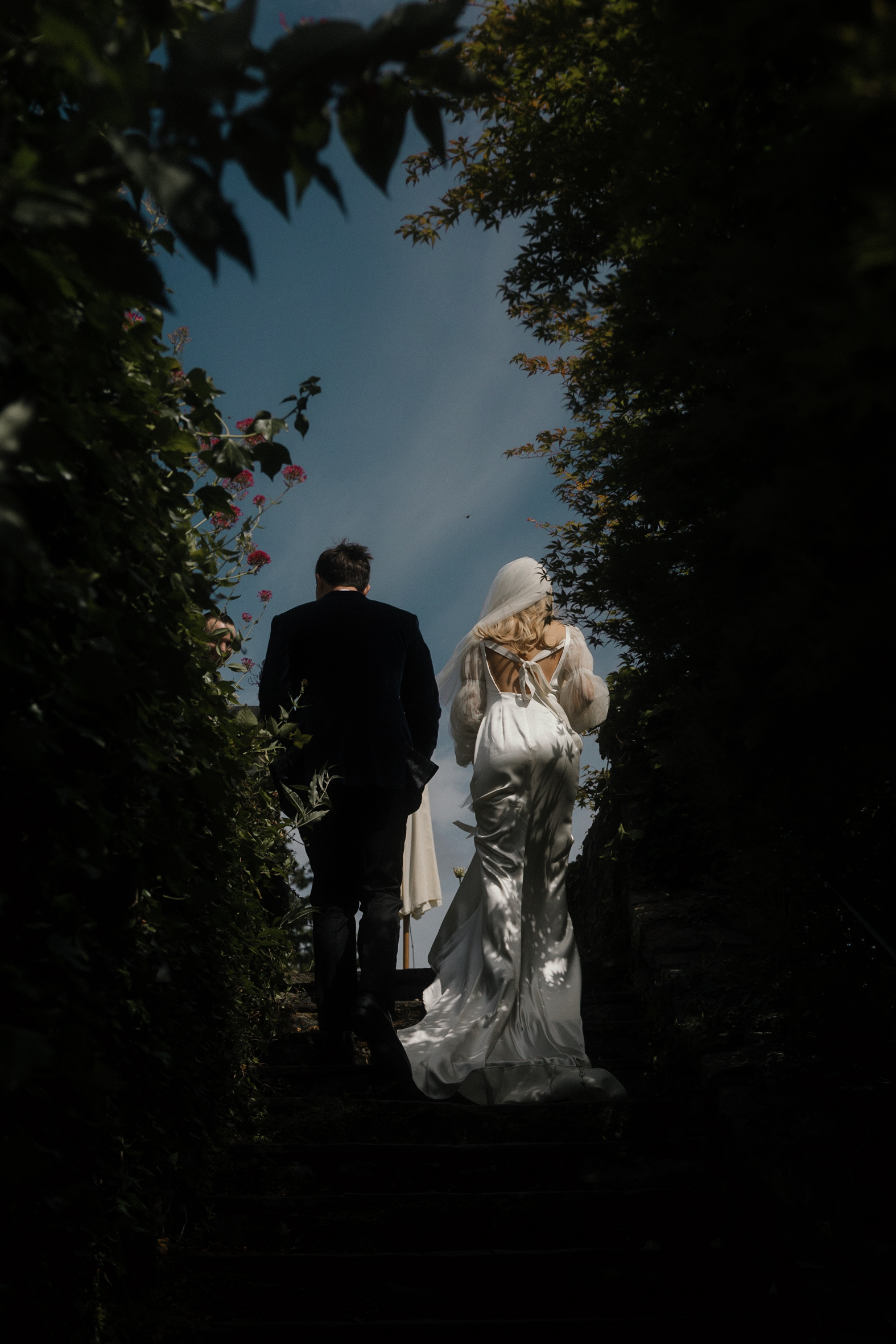 bride and groom walking up steps at their Ballynahinch Castle wedding, Connemara captured cinematically by Chris Copeland weddings