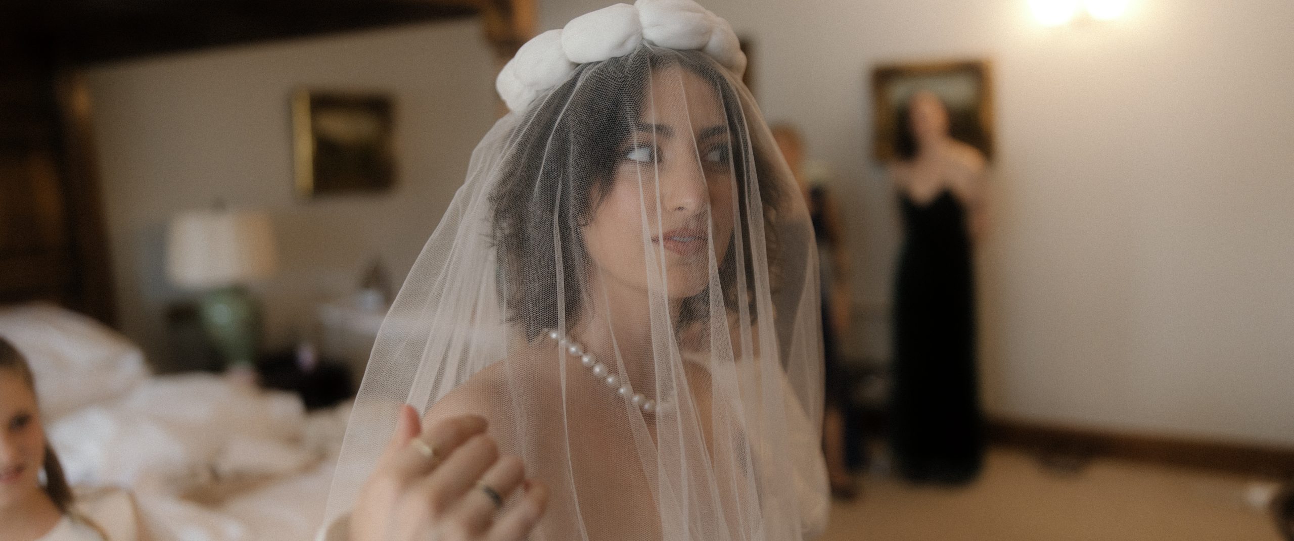 a hip young bride checks her veil just before she leaves to meet for the wedding ceremony luxury wedding ireland